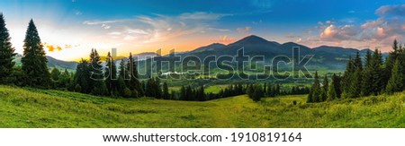Panoramic landscape with sunset in mountains. Royalty-Free Stock Photo #1910819164