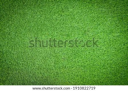 Top view of green artificial grass texture and background. Artificial turf grass for decorative in the garden, football field and golf course. Green backdrop and wallpaper. Copy space for your text.