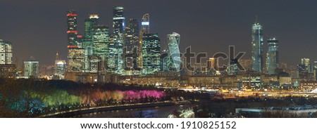 Long exposure photography of Moscow cityscape during winter night. Cold weather. Blurred lights of the city. Bright lighting of Moskva river embankment. Skyscrapers of Moscow business district Royalty-Free Stock Photo #1910825152