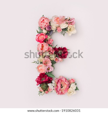 Letter E made of real natural flowers and leaves. Flower font concept. Unique collection of letters and numbers. Spring, summer and valentines creative idea. Royalty-Free Stock Photo #1910826031