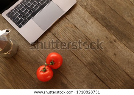The ultimate Italian style background - a clean workspace for the best focus and flow. All you need is a laptop, two fresh tomatoes and a macchinetta.