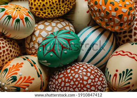 Happy Easter!Colorful hand painted decorated Easter eggs, CZ kraslice. Handmade Easter eggs in wooden basket.Spring decoration background. Festive tradition for Eastern European countries.