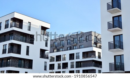 Modern apartment building in sunny day. Exterior, residential house facade. Royalty-Free Stock Photo #1910856547