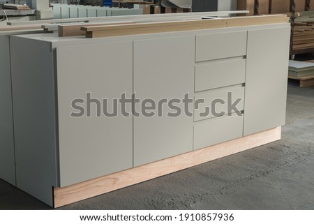 Bespoke cabinet construction in joinery workshop. Royalty-Free Stock Photo #1910857936