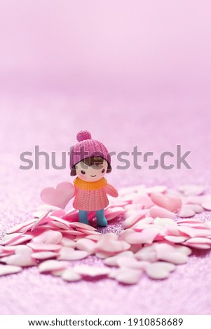 cute toy doll and pink hearts on glitter pink background. girl toy with heart. 14 february, Valentine's day, Love, romance concept.