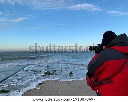 Man taking pictures in Borkum, Germany