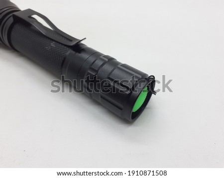 Black Electric LED Flashlight Powered by Rechargeable Battery in White Isolated Background