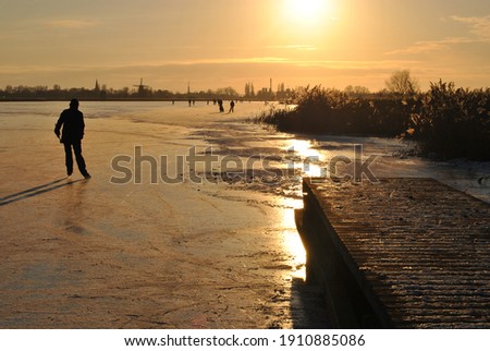 skating ice on the lake in the sunset late afternoon