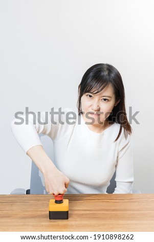 Woman pushing the emergency switch