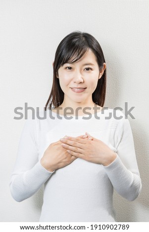 Woman holding hands in front of her body