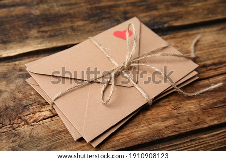 Stack of envelopes on wooden table. Love letters Royalty-Free Stock Photo #1910908123