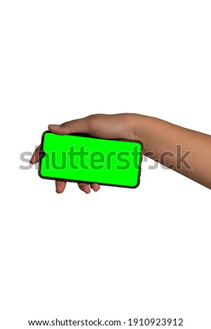Man hand holding black smartphone and green screen.Isolated on white background, with copy space.