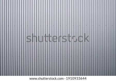 Texture of a corrugated sheet metal aluminum facade Royalty-Free Stock Photo #1910933644