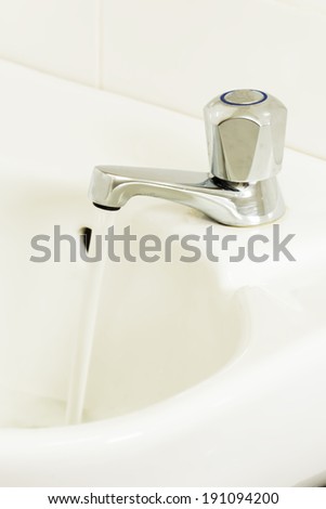 Open water tap with flowing water