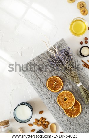 Relax concept. Cozy, comfortable, knitted blanket with a bouquet of lavender, a glass of milk and healthy snack for good sleep. Insomnia or depression treatment for sleepless nights. Top view