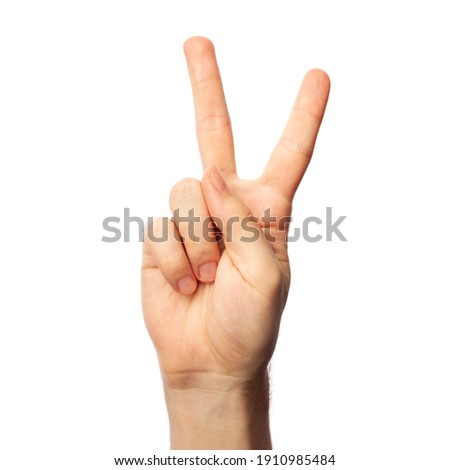 Man showing letter V isolated on white background, closeup. Finger spelling alphabet in American Sign Language. ASL concept