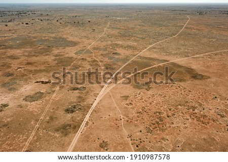 Lonesome roads across the desert plain Royalty-Free Stock Photo #1910987578