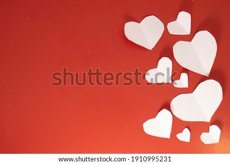 frame of white valentines hearts on red isolated background with copy space