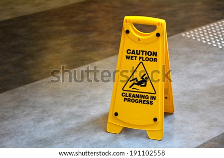 Slippery floor surface warning sign  and symbol in building, hall, office, hotel , restaurant, restroom. Concept photo danger.No people. Copy space