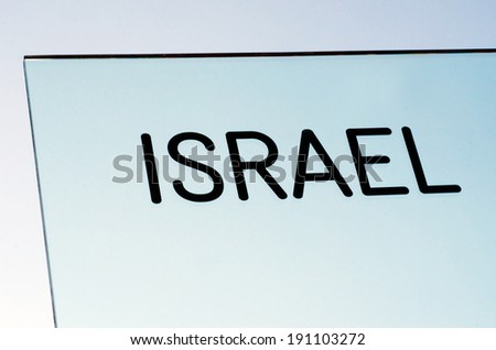Israel sign and symbol on a glass over sky background.