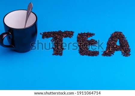 Tea party concept, cup of tea with the inscription tea, on a blue background.