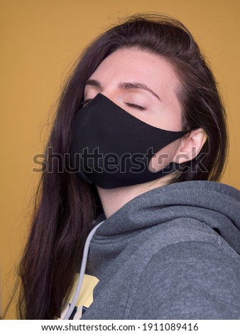 woman with mask on yellow background