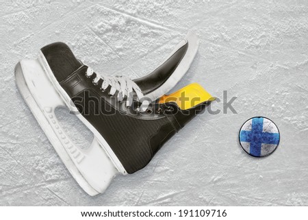 Hockey skates and puck depicting the Finnish flag