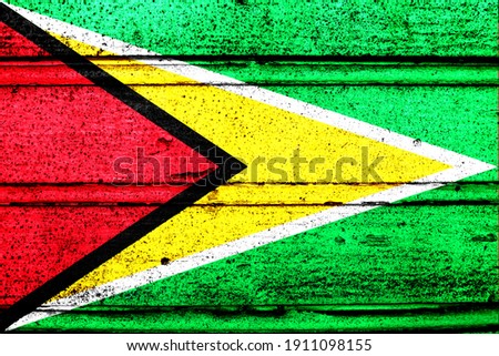 National flag of Guyana, abbreviated with gy; a realistic 3d image of the national symbol from an independent country painted on a wooden wall