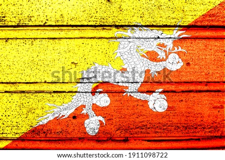 National flag of Bhutan, abbreviated with bt; a realistic 3d image of the national symbol from an independent country painted on a wooden wall