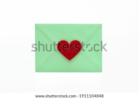 Heart on a green envelope isolated on white background