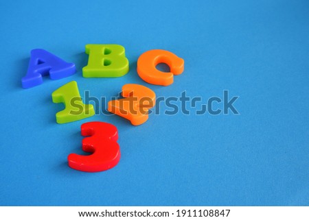 ABC alphabet letters and 123 numbers on light blue background with copy space on the right side