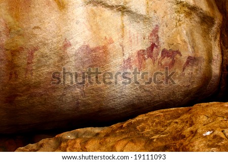 prehistoric aboriginal social life scenes. african bushmen (San people) tribal wall painting in mountain cave of south africa (western cape)