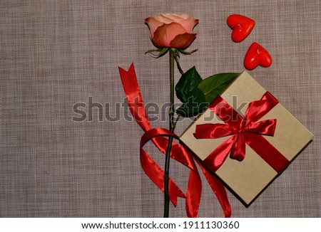 Gift box with red bow, pink rose and aroma candles white shape of heart. Top view. Space for text
