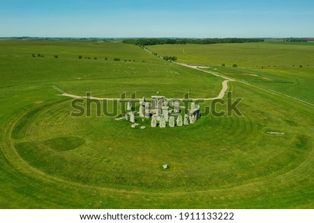 Aerial view of Stonehendge on a sunny day in summer with no people around. This is a historic site with a ring of standing stones, it was believed to be a burial site. Blue sky and space for text. Royalty-Free Stock Photo #1911133222