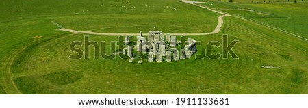 Banner - Aerial view of Stonehenge - sunny day in summer with no people around. This is a historic site with a ring of standing stones, it was believed to be a burial site. Blue sky and space for text Royalty-Free Stock Photo #1911133681