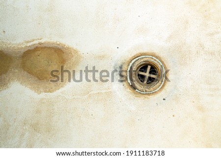 Bad dirty hole in the bathroom. Unsanitary condition of bath element close-up. Plumbing abstract background Royalty-Free Stock Photo #1911183718