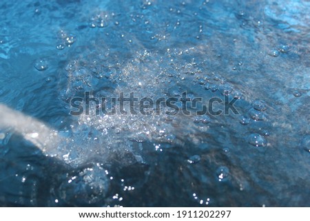 Creative Water on Deep Blue Splash Bubbles Lighted on Sun