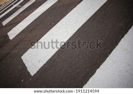 Pedestrian crossing during day. pedestrian lanes on asphalt.