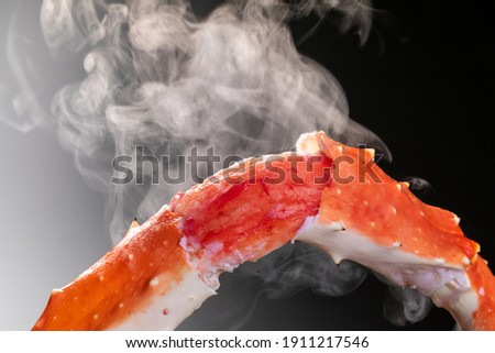 A scene where steam rises from a boiled king crab Royalty-Free Stock Photo #1911217546