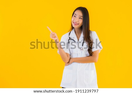 Portrait beautiful young asian doctor woman smile happy work in hospital and clinic on yellow isolated background