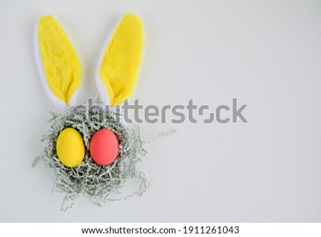 Easter bunny rabbit with yellow ears in a medical mask on a white background with copy space. Creative concept of Easter children's crafts.