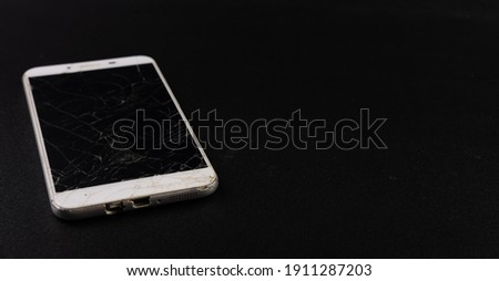 Cracked cellphone screen with black background