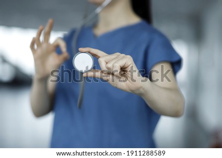 Close up of doctor holding stethoscope.Health care and medicine concept
