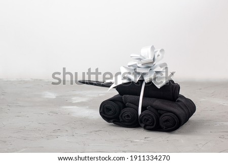 Handmade tanks of socks as gift to men on February 23 on grey background with copyspace