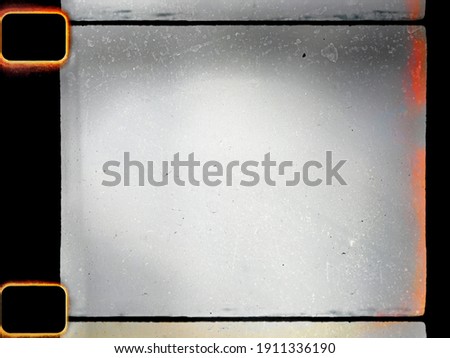 empty or blank 16mm film frame with black border, dust and light leak. film scan. Royalty-Free Stock Photo #1911336190