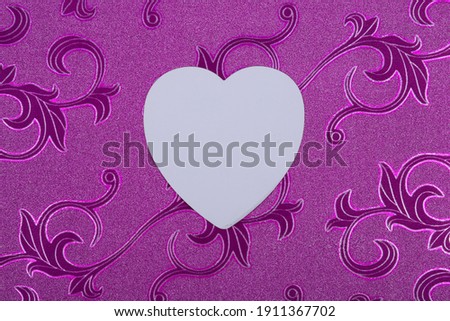 White heart on pink textured floral background. Valentines day card with copy space.