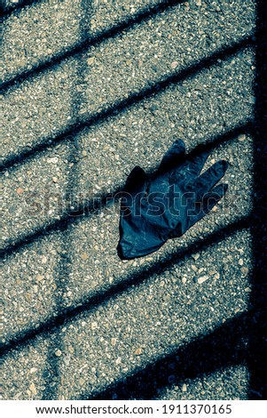 the glove, a symbol in 2020 and 2021 during the pandemic across the world. in a monochrome style with shadows and light 