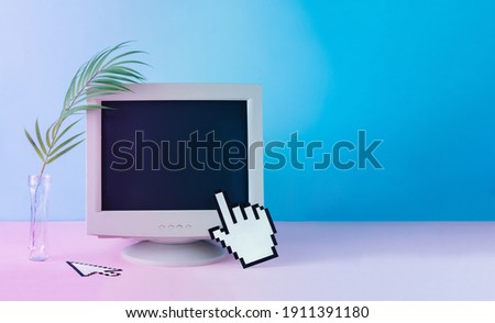 Retro vintage computer monitor with tropical palm leaf. Blue and purple colored lights. Creative minimal cyberwave background. Retro futurism.