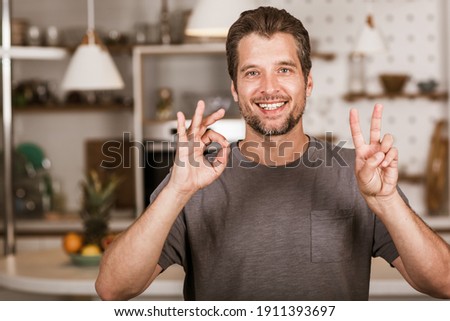Young man showing gesture in sign language