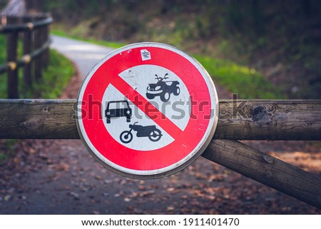 Road traffic prohibition sign on the wooden barrier.